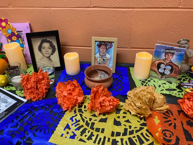 spap day of the dead altar with photos and flowers