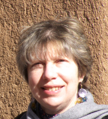 Caroline Eades headshot on a brown background