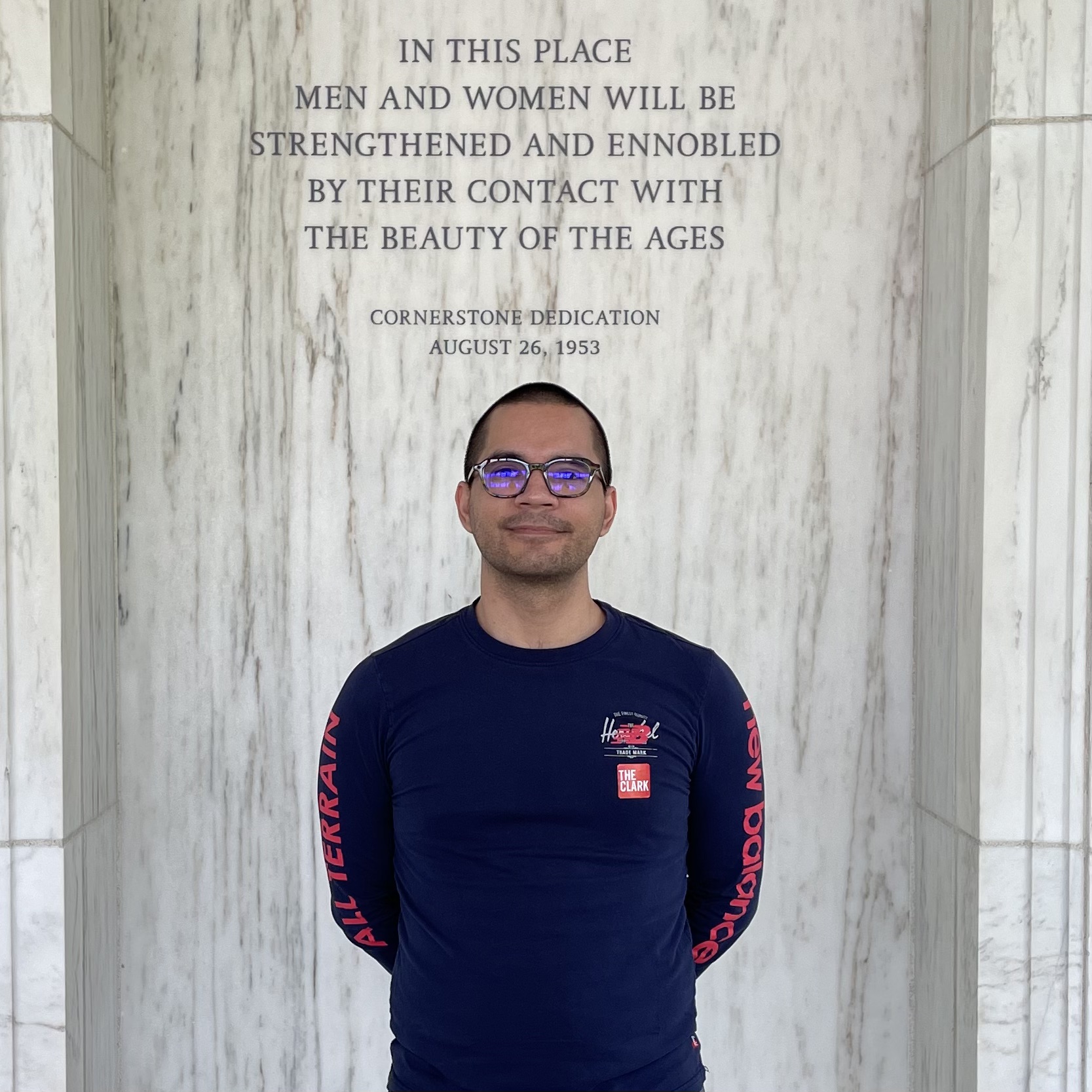 Graduate student Daniel Guerrero at the Clark Institute in Western Massachusetts. Behind him, a stone engraving that reads: "In this place men and women will be strenghtened and ennobled by their contact with the beauty of the ages"