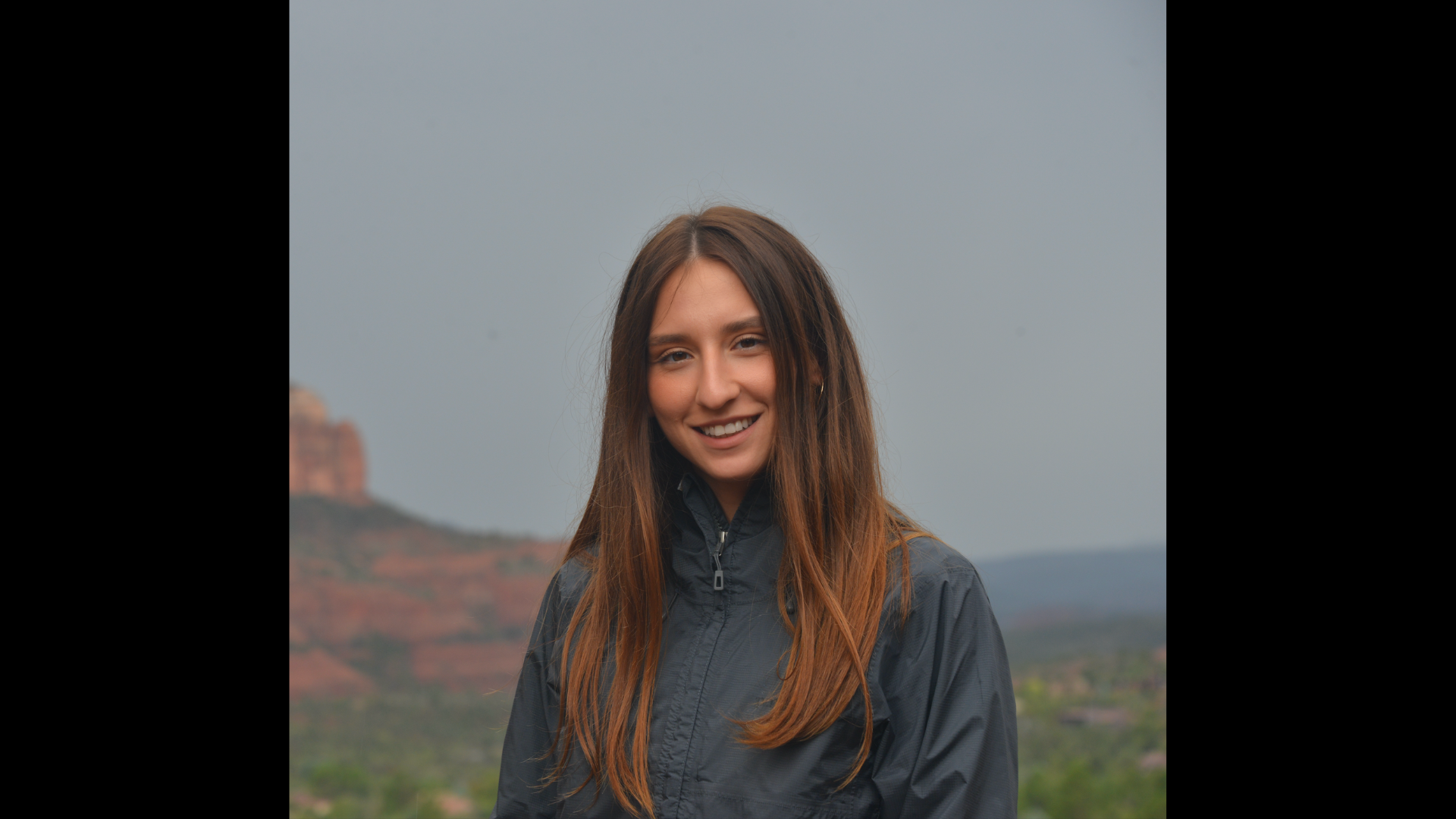 tetiana tytko in front of a mountain landscape
