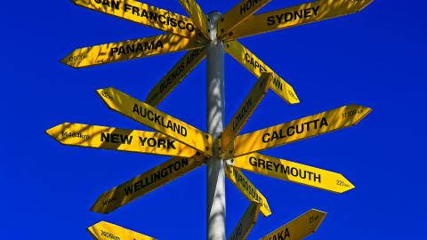 Signs that point to various world cities